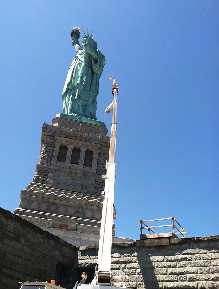 Statue of Liberty 2014 with a crane lifting the elevator motor in place