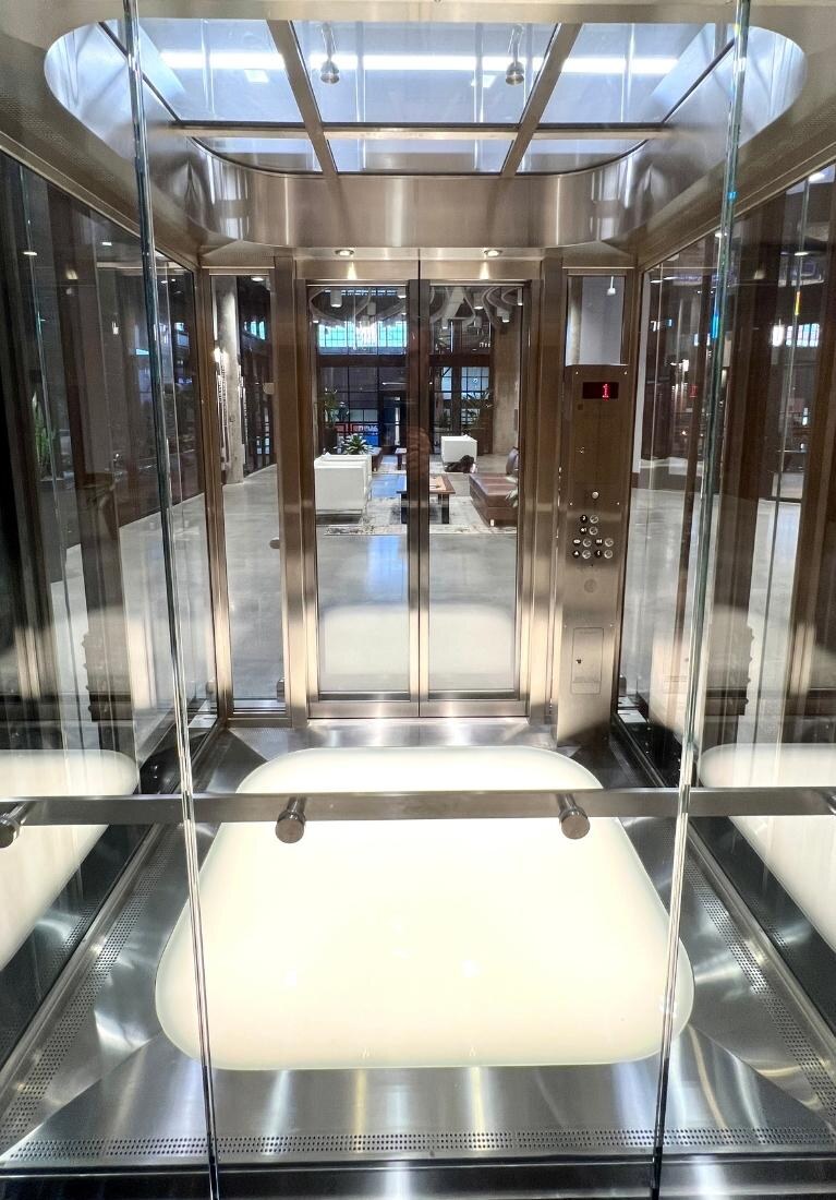 Electric Works Glass Elevator Installation by Liberty Elevator - Glass Cab